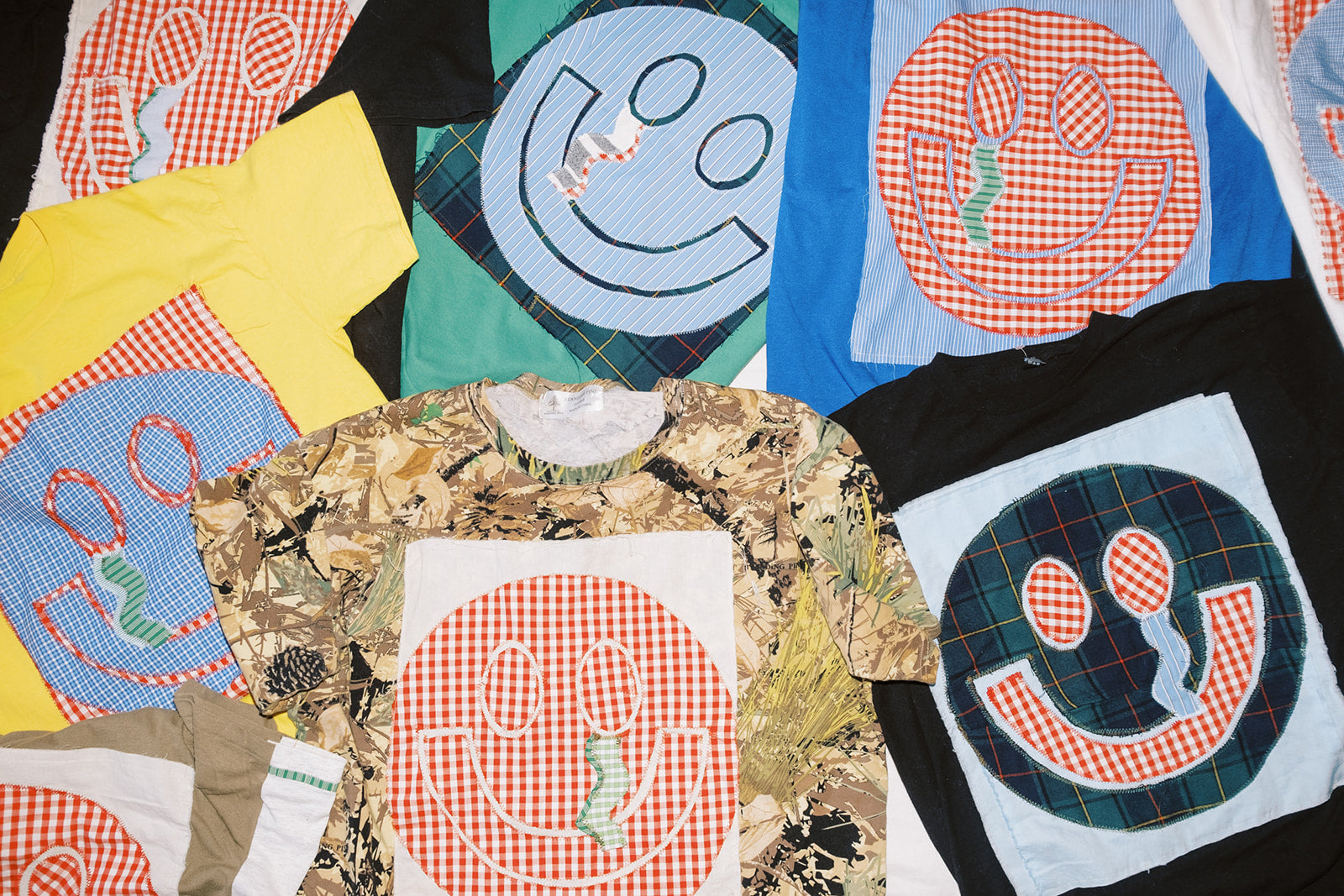 An array of colorful, vibrant, upcycled and patchwork tees, t-shirts, handmade in Brooklyn with thrifted and vintage materials